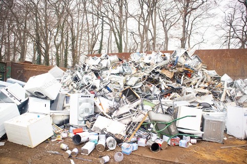 a pile of scrap metal sitting at a dump site