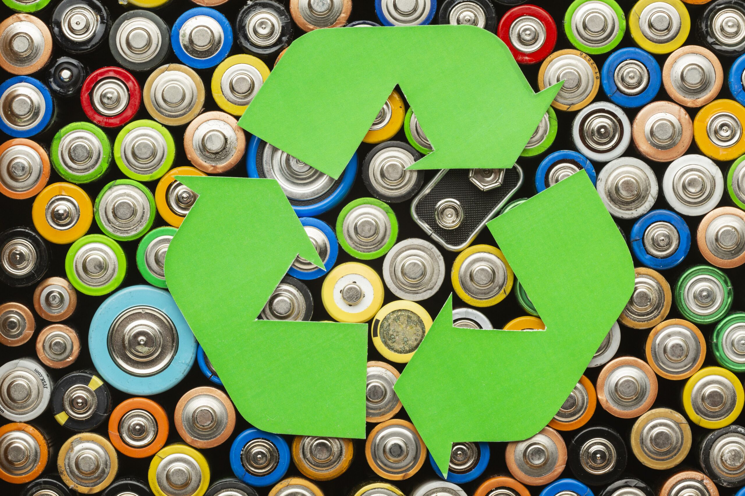 A battery pollution waste with recycle symbol